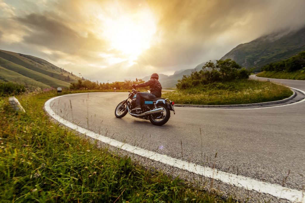 Motorbike on road in france infront of sunset/rise. motorbike touring in France from St Malo