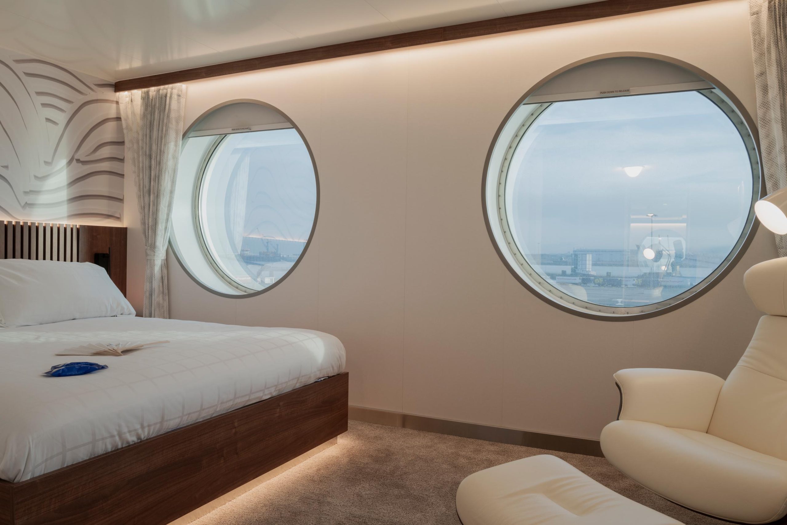 Admiral suite on the MV Saint-Malo with queen-size bed and lounge area