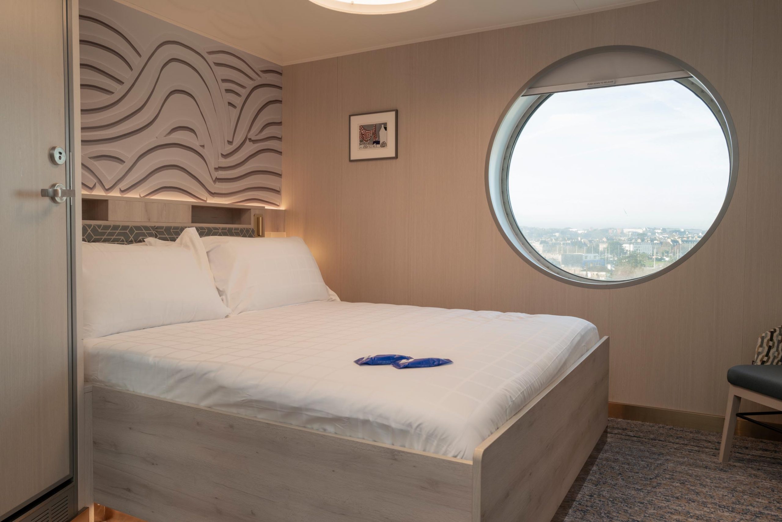 2-berth Commodore cabin on the MV Saint-Malo with queen-size bed and armchairs